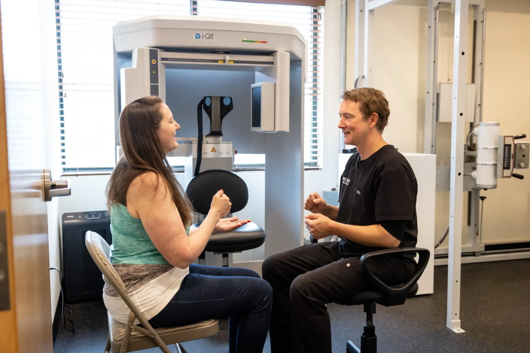 Dr. McCanse administering the Luria Sequence neurological exam to assess cognitive and motor coordination during a NeuroStructural evaluation at Precision Chiropractic in Vermont.