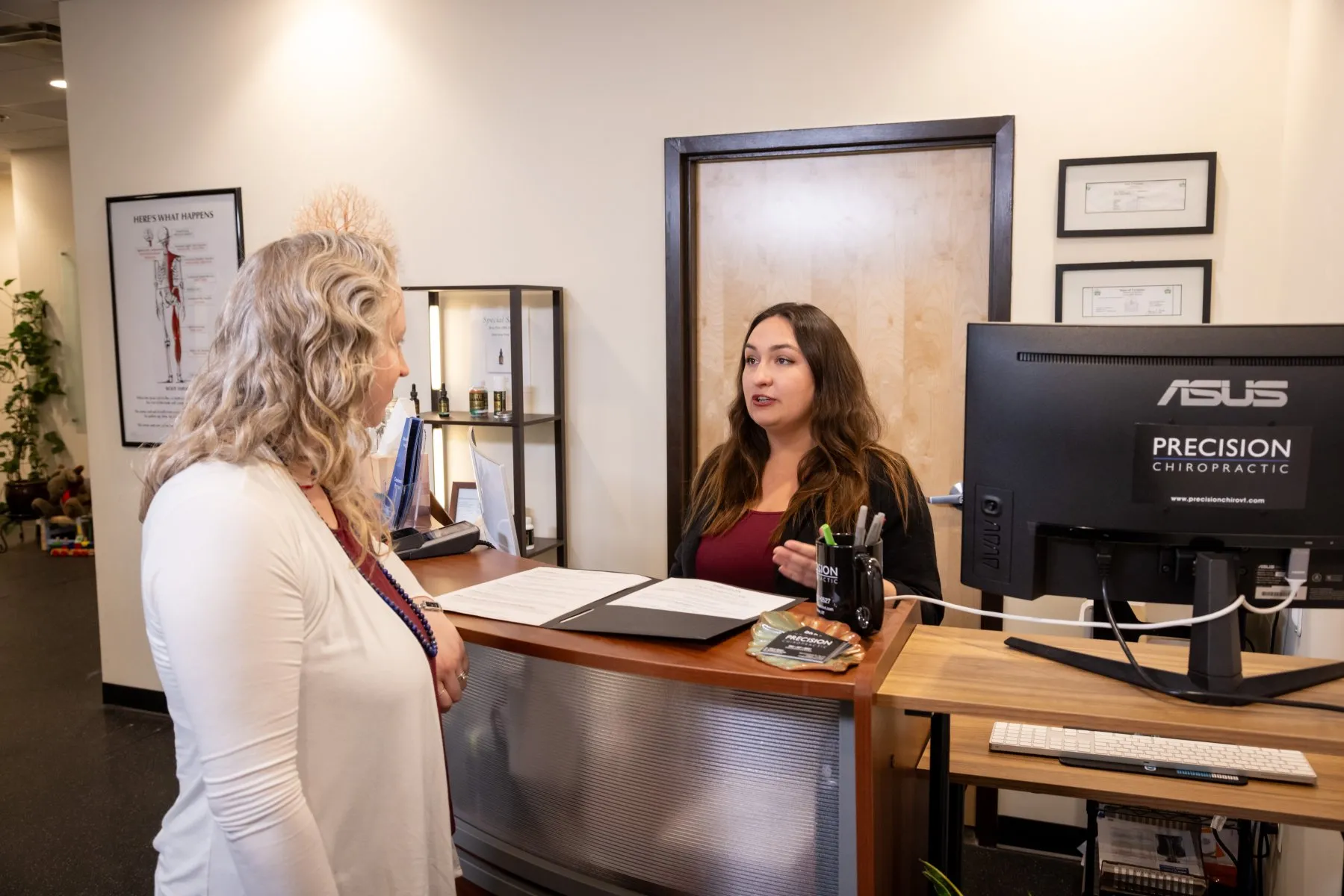 Upper cervical chiropractor Dr. McCanse discussing structural spinal shifts and nervous system-related symptoms with a patient at Precision Chiropractic in Vermont.